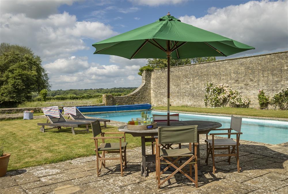 Additional garden furniture next to the pool at Long Barn, near Cirencester