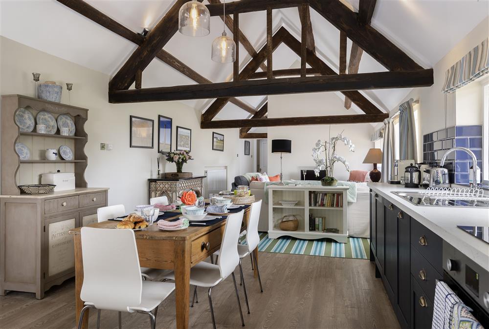 Ground floor: Open-plan living area with dining table seating six guests at Long Barn, near Cirencester