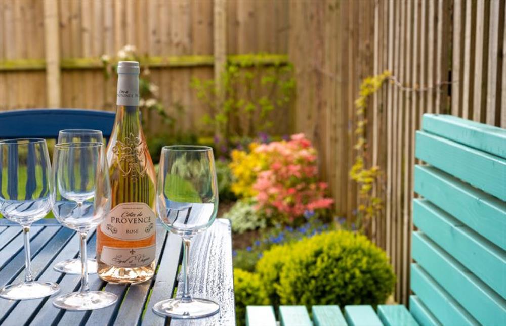Enjoy a refreshing glass of wine outside in the alfresco dining area  at Long Meadow, Great Bircham near Kings Lynn