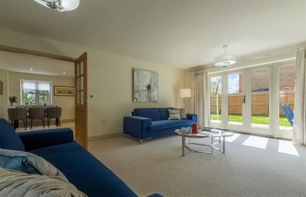The sitting room has bi-fold doors to the garden at Long Meadow, Great Bircham near Kings Lynn