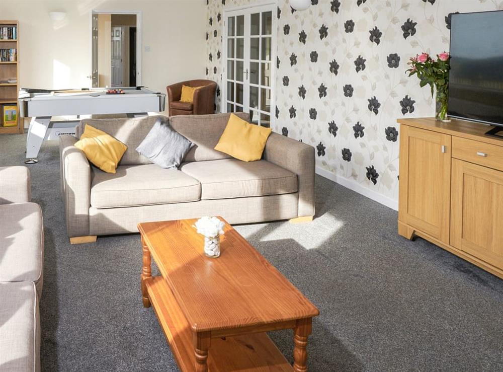 Living room with games area at Longmead in Near Paignton, Devon
