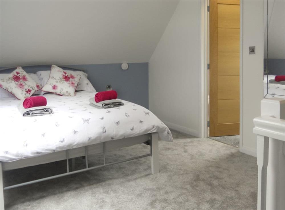 Comfortable double bedroom with en-suite bathroom at The Cob Barn, 