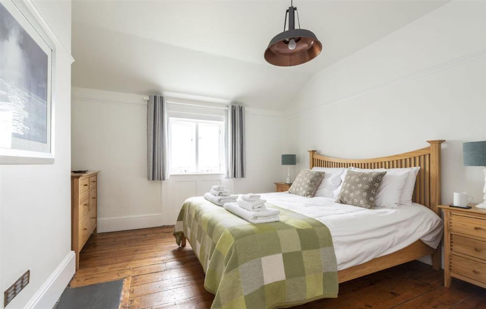 Bedroom with 5’ king-size bed and sea views at Longships, The Lizard