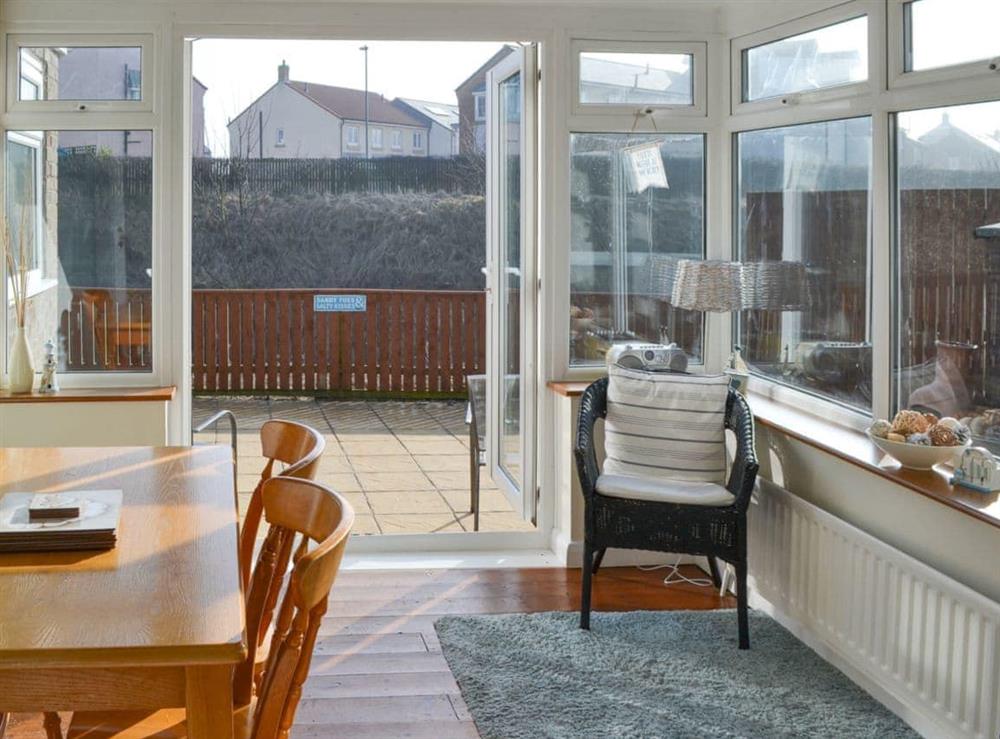 Dining area in the sun room at Longstone Bungalow in Beadnell, Northumberland
