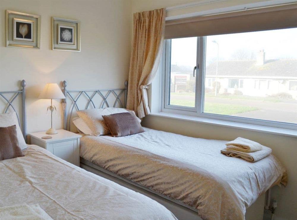 Welcoming and attractive twin bedd room at Longstone Bungalow in Beadnell, Northumberland