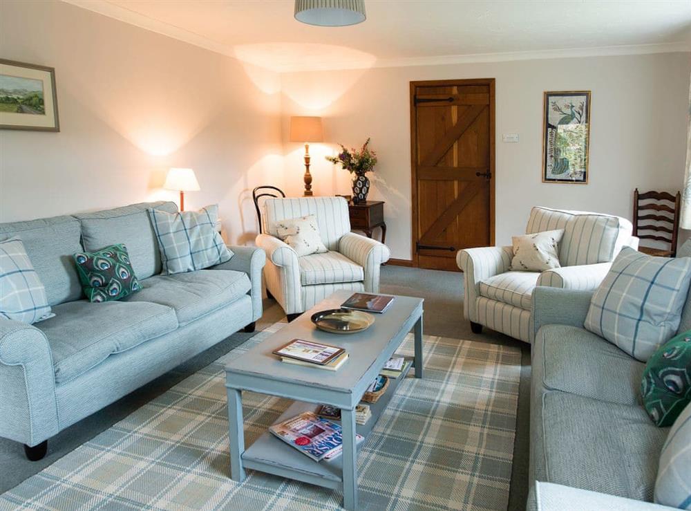 Cosy living room with open fire at Lookin How (DELUXE) in Penrith, Cumbria