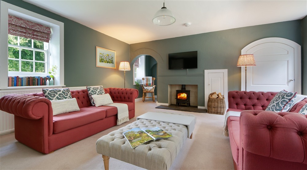 The sitting room, with sofas, television and woodburner at Lookout Cottage in Alnwick, Northumberland