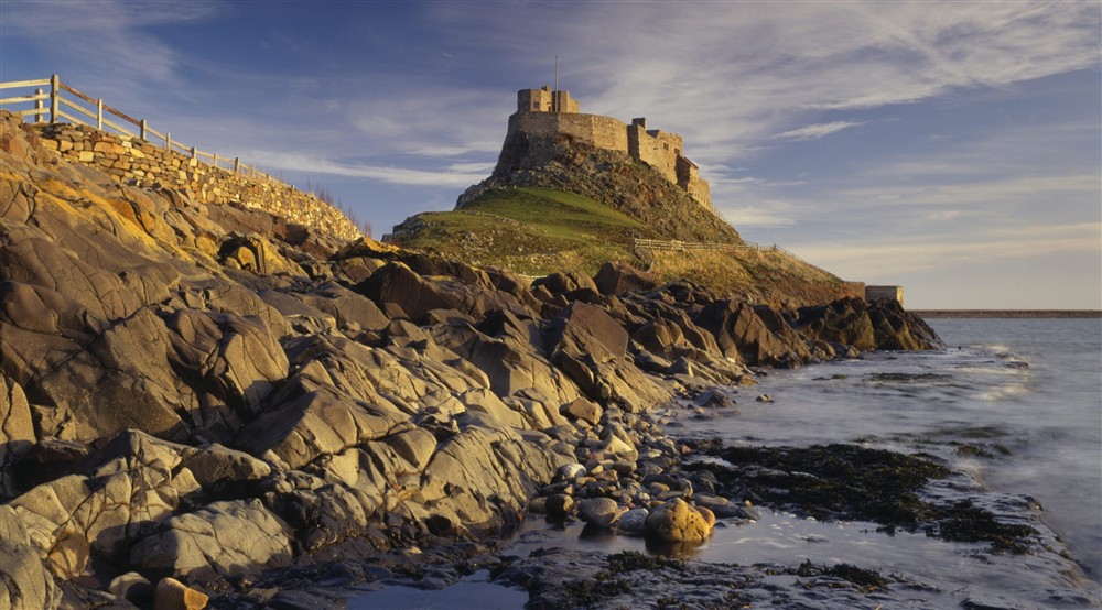View of the rocky crag and causeway below Lindisfarne Castle, Northumberland, taken at Lookout Cottage in Alnwick, Northumberland
