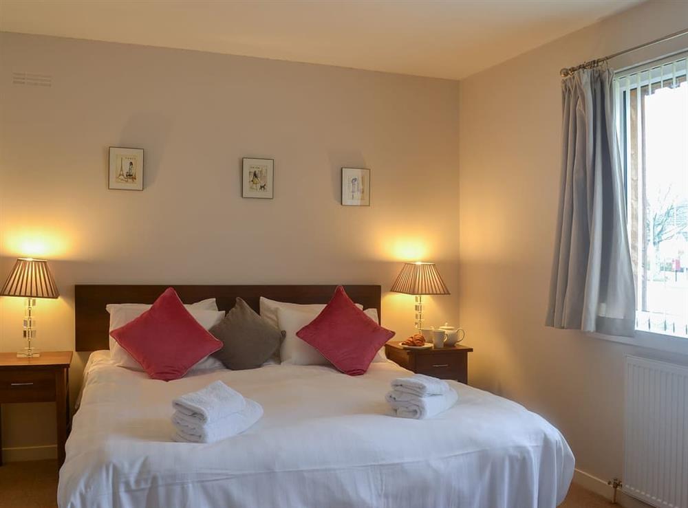 Bedroom with kingsize bed at Loramore in Aviemore, Highlands, Inverness-Shire