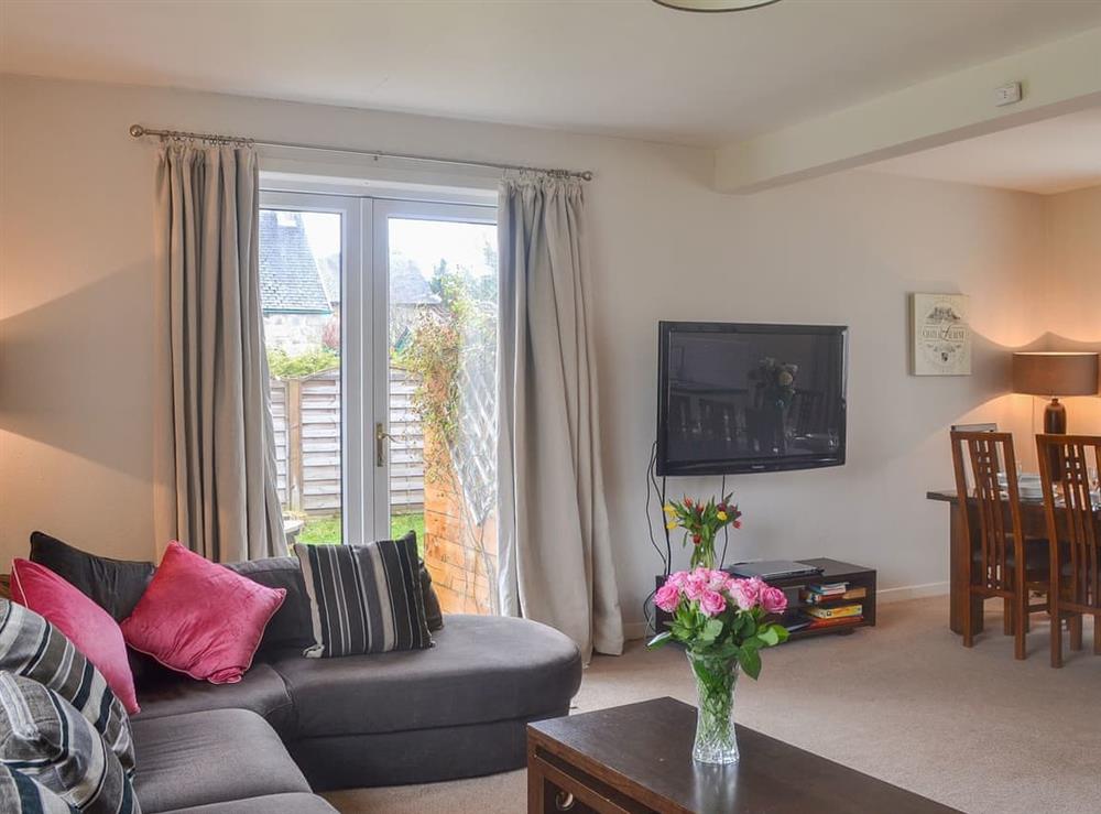 Delightful living space with French doors leading to the garden at Loramore in Aviemore, Highlands, Inverness-Shire