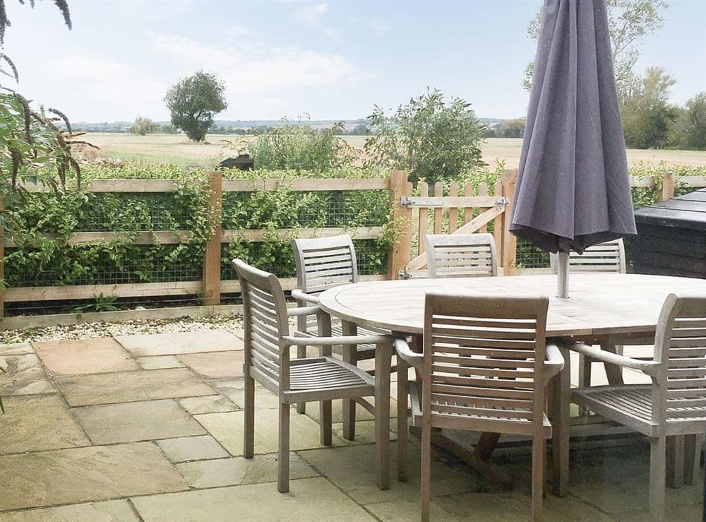 Patio area with mature hedge and shrubs. at Lords View in Ruckinge, near Ashford, Kent