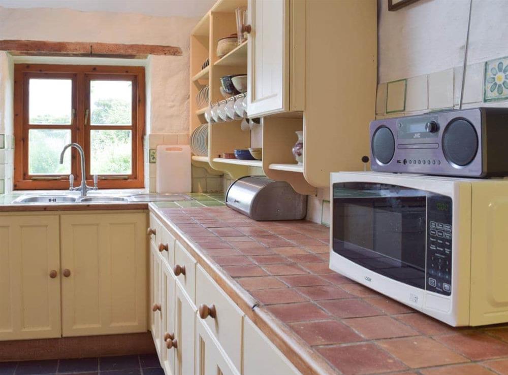 The kitchen/diner boasts tiled worktops and quarry-tiled floor at Lordship Farmhouse in Wolfscastle, near Haverfordwest, Dyfed