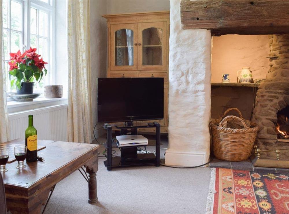 The living room boasts a grand fireplace at Lordship Farmhouse in Wolfscastle, near Haverfordwest, Dyfed