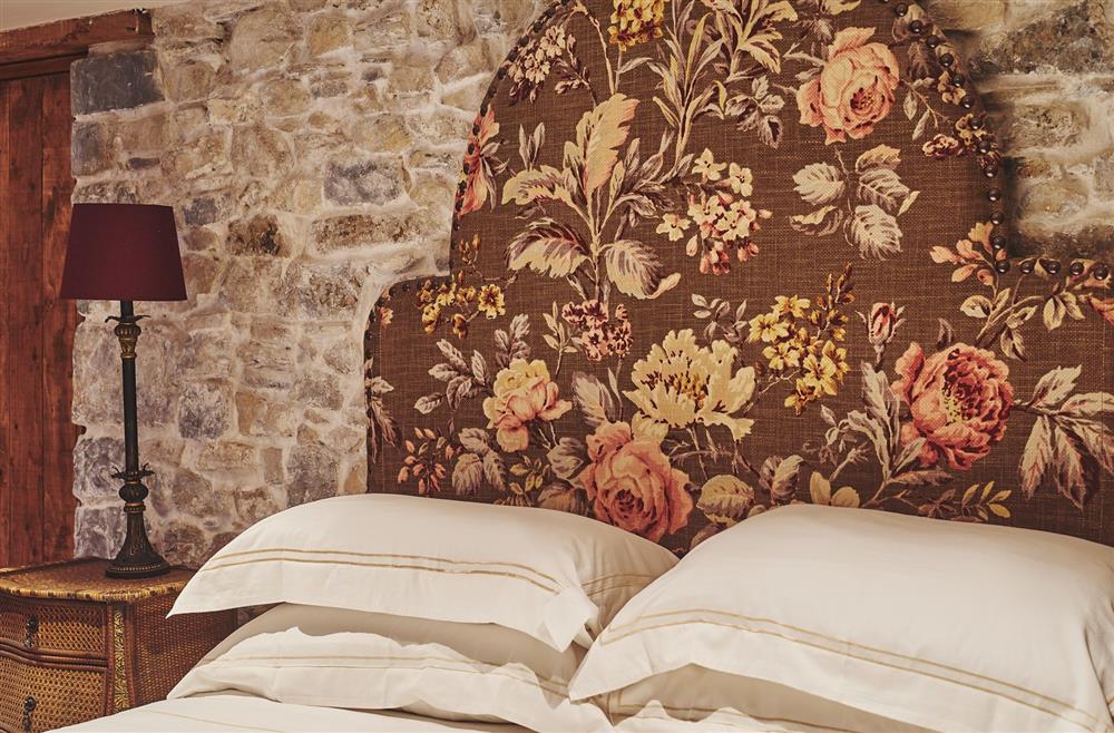 The floral headboard of the king-size bed