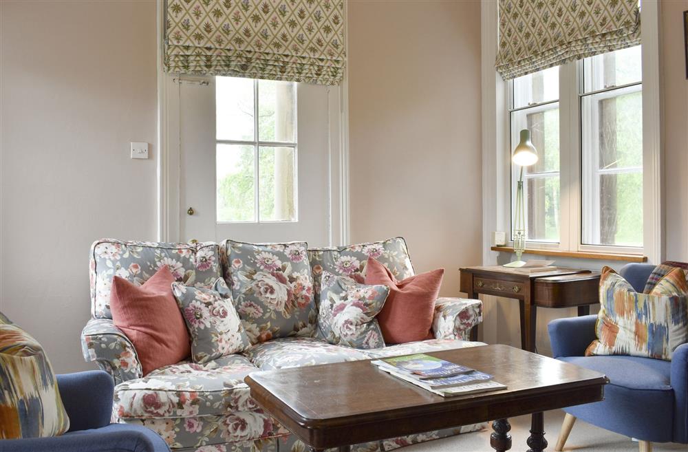 Sitting room with large windows overlooking the grounds