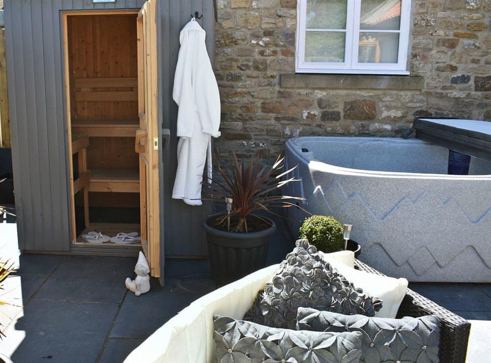 Impressive outdoor area with sauna and hot tub at Low Pasture Cottage in Hudswell, near Richmond, North Yorkshire