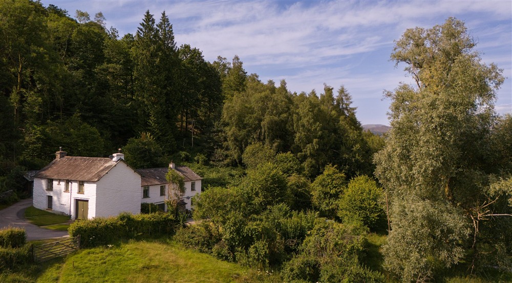 The exterior of Restharrow (the building on the right, the two windows on the left of the top row) and neighbours Tanner Brow (on the left) and another home (on the right), Cumbria at Low Strawberry Gardens in Nr Hawkshead, Cumbria