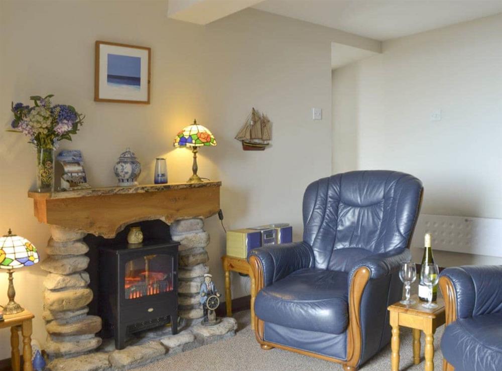 Cosy lounge with feature fireplace at Low Tide in Cellardyke, near Anstruther, Fife