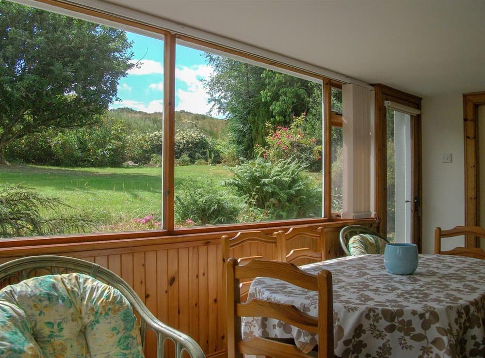 Dining area with garden views at Lower Brae in Strath Oykel, by Ardgay, Highlands, Ross-Shire