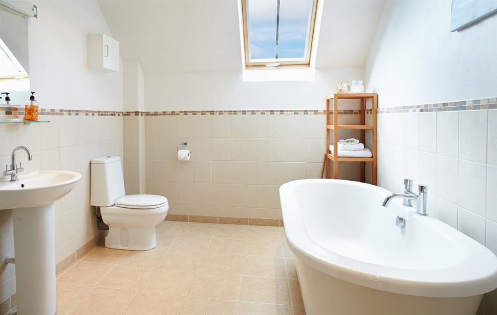 Large family bathroom with a free-standing bath and separate shower at Lower Curscombe Barn, Feniton