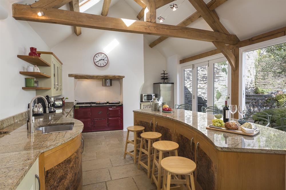 Curved island with breakfast bar and stools at Lower Easton Farmhouse in , Nr Salcombe