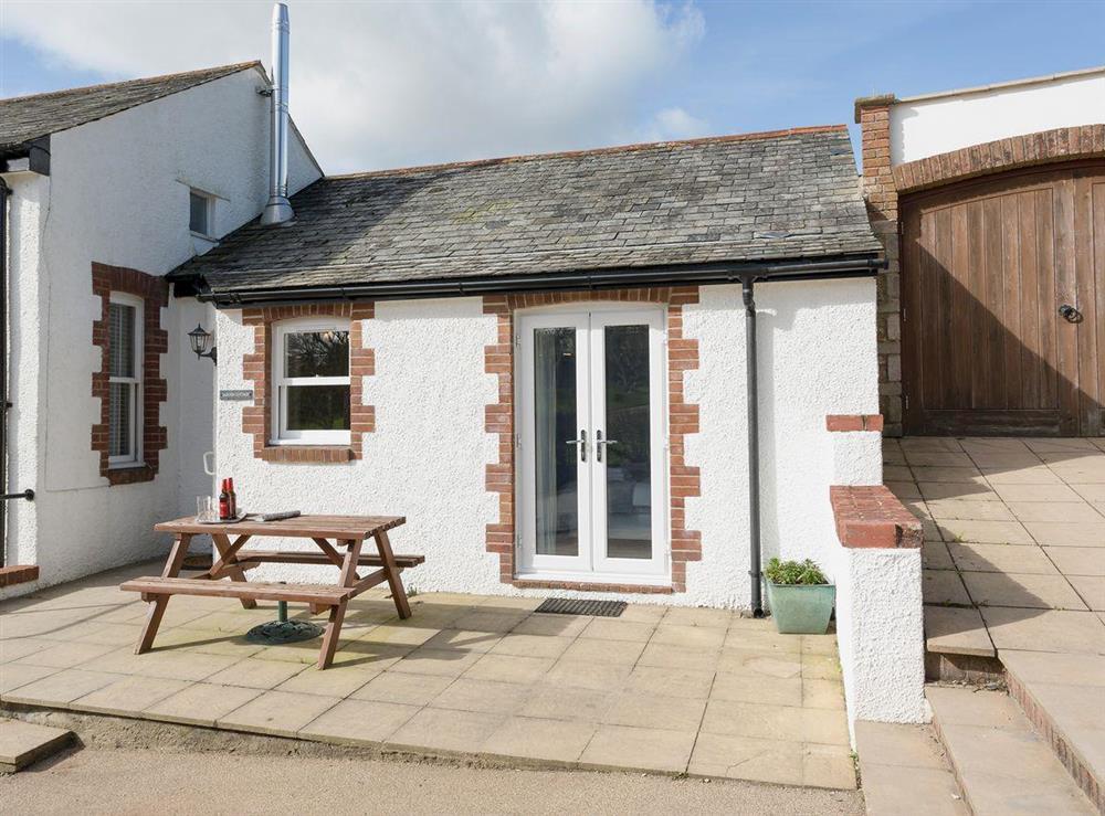 Attractive holiday home with outdoor furniture on patio at Garden Cottage, 