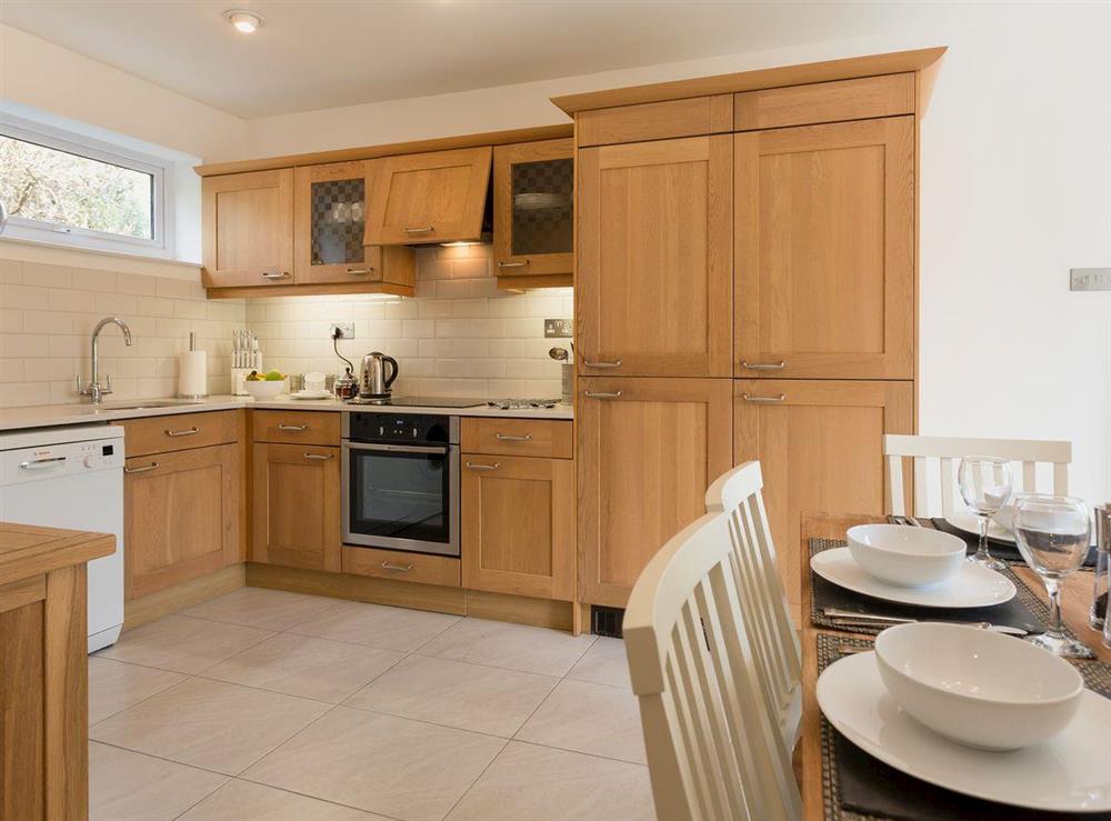 Well-equipped kitchen with dining area at Garden Cottage, 