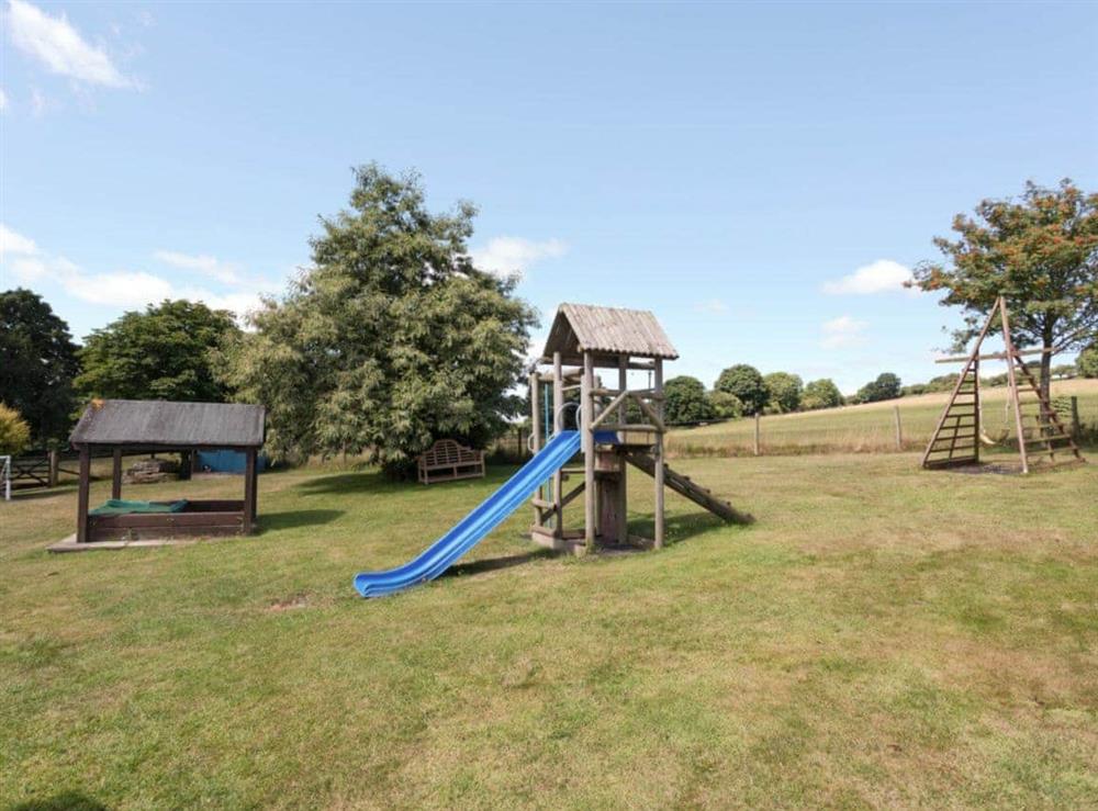 Outdoor recreation area with children’s play equipment at Pond View, 