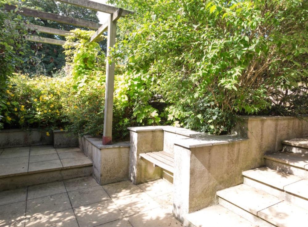 Enclosed courtyard/patio to side of cottage with built-in seating at Stable Corner, 