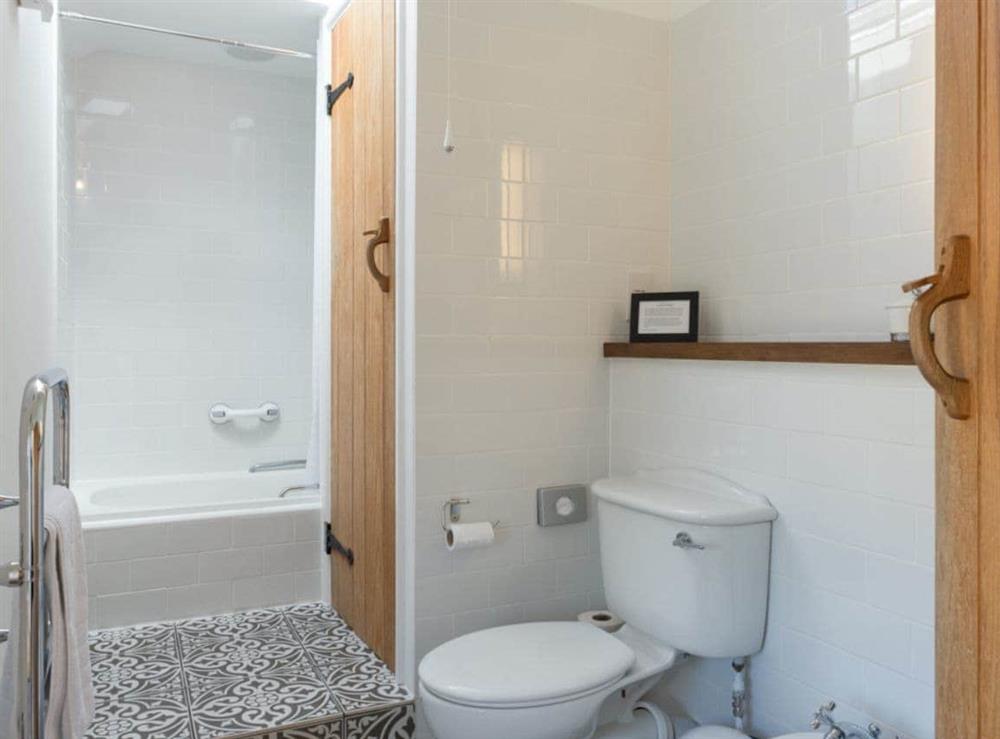 Family bathroom with shower over bath at Torfield, 
