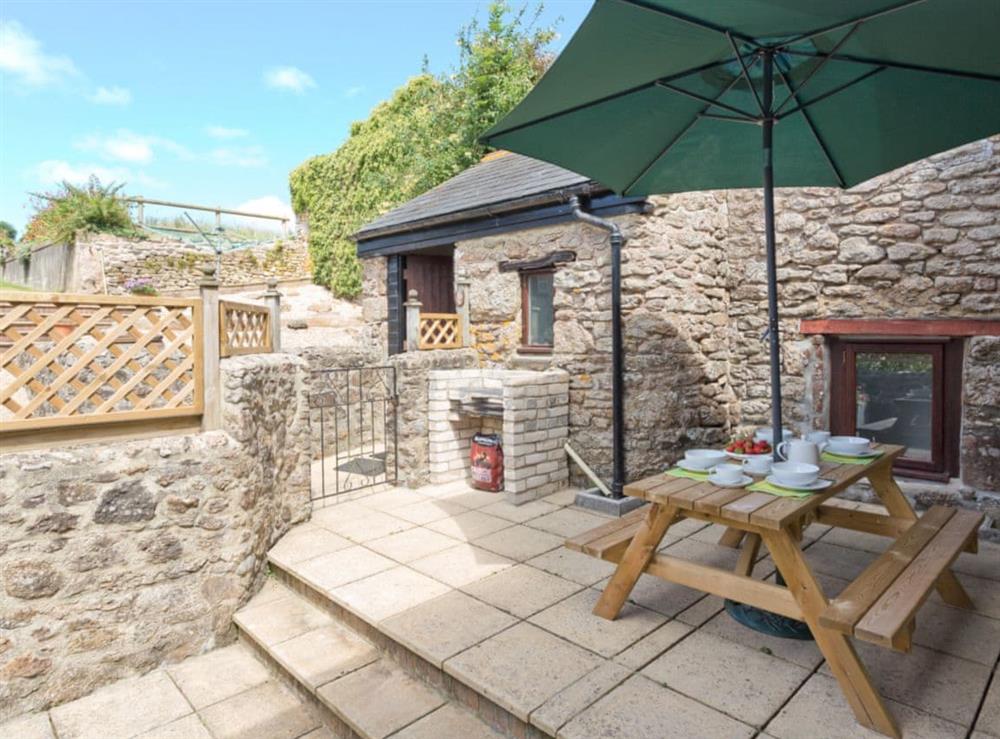 Outdoor seating and built-in BBQ in rear courtyard at Torfield, 