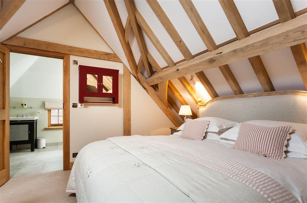 The bedroom boasts exposed oak beams at Lower Farm Barn, Hungerford