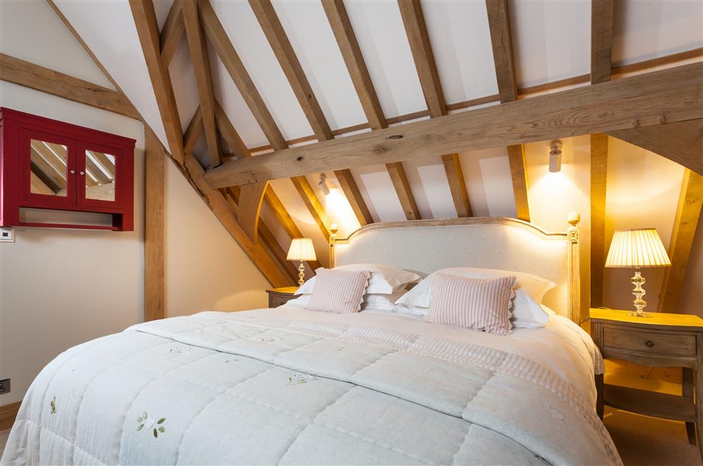 The bedroom with a 6’ super-king size bed and en-suite shower room at Lower Farm Barn, Hungerford