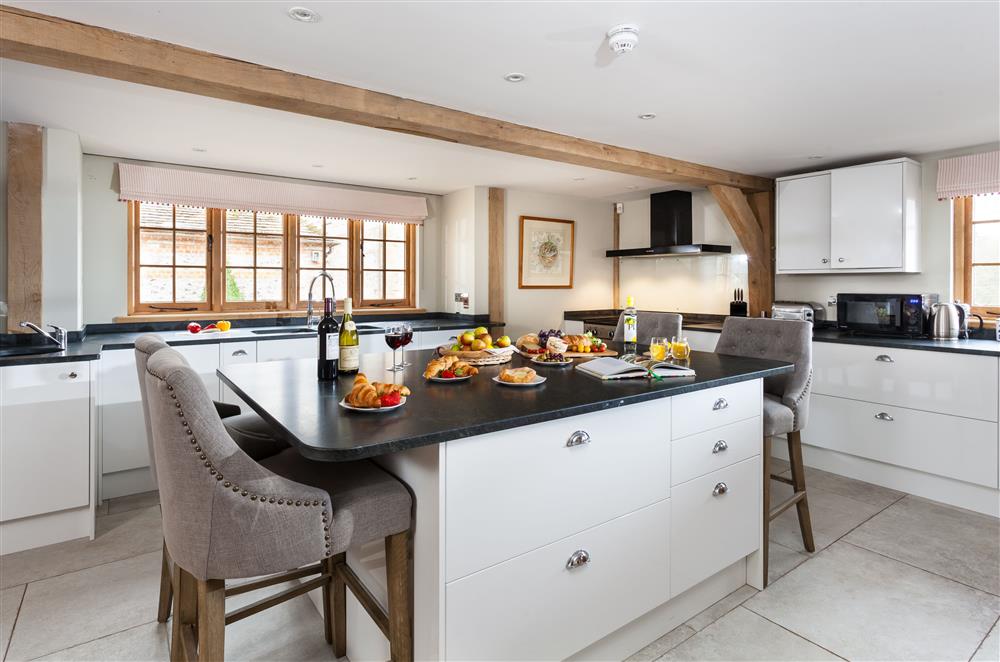 The kitchen, with sit up island seating for four guests at Lower Farm Barn, Hungerford