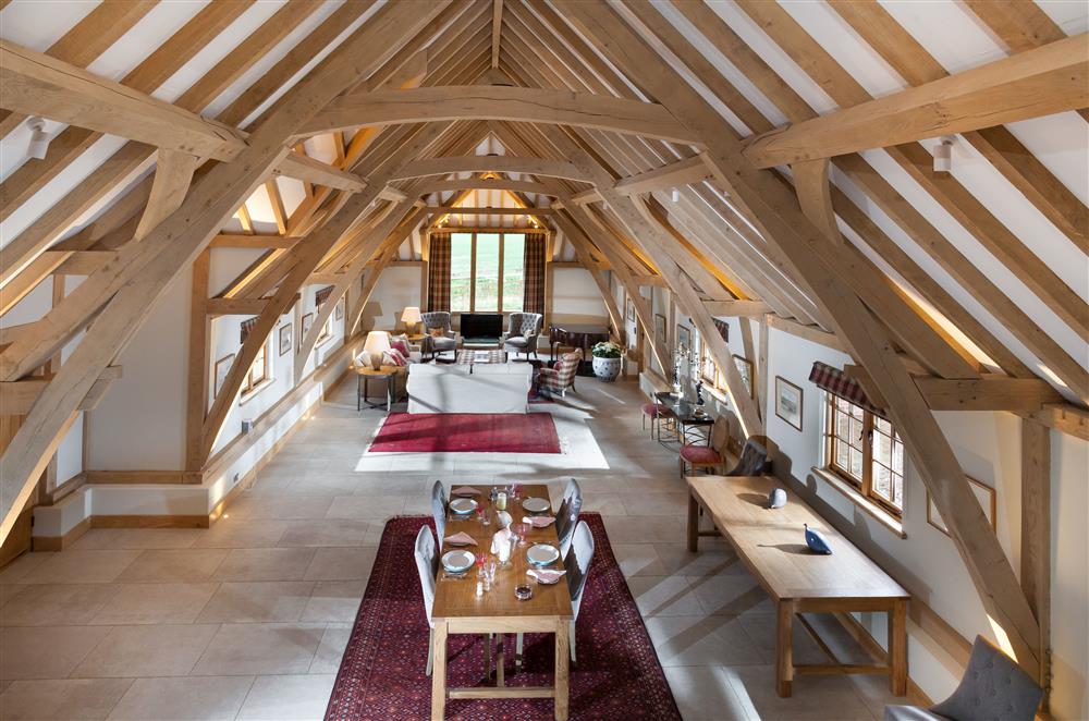 The open-plan sitting and dining room boasts an exposed oak vaulted ceiling at Lower Farm Barn, Hungerford