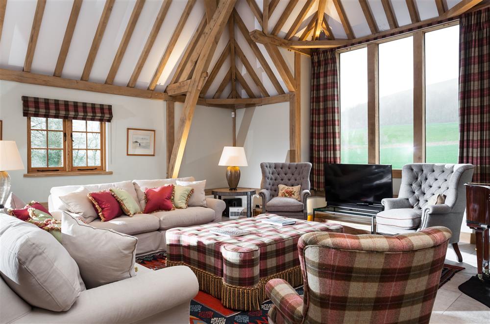 The sitting area enjoys countryside views from the large feature window at Lower Farm Barn, Hungerford