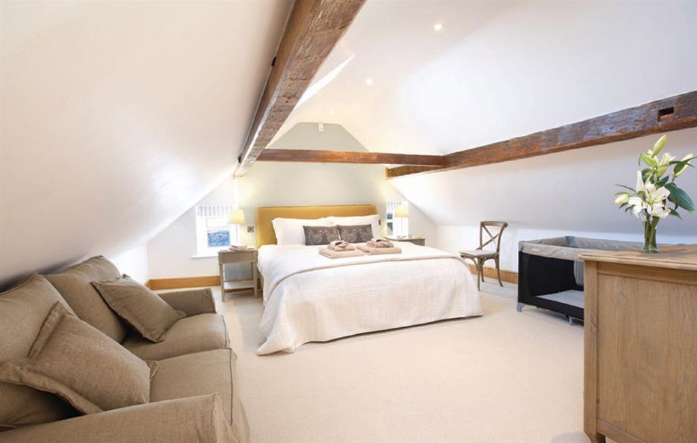 Bedroom five on the second floor with a 6’ super-king size bed at Lower Farmhouse,  Todenham, Moreton-in-Marsh