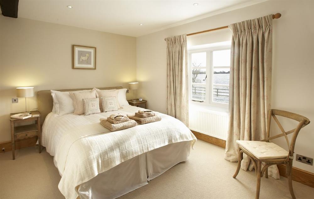Bedroom four with a 5’ king-size bed and en-suite bathroom at Lower Farmhouse,  Todenham, Moreton-in-Marsh