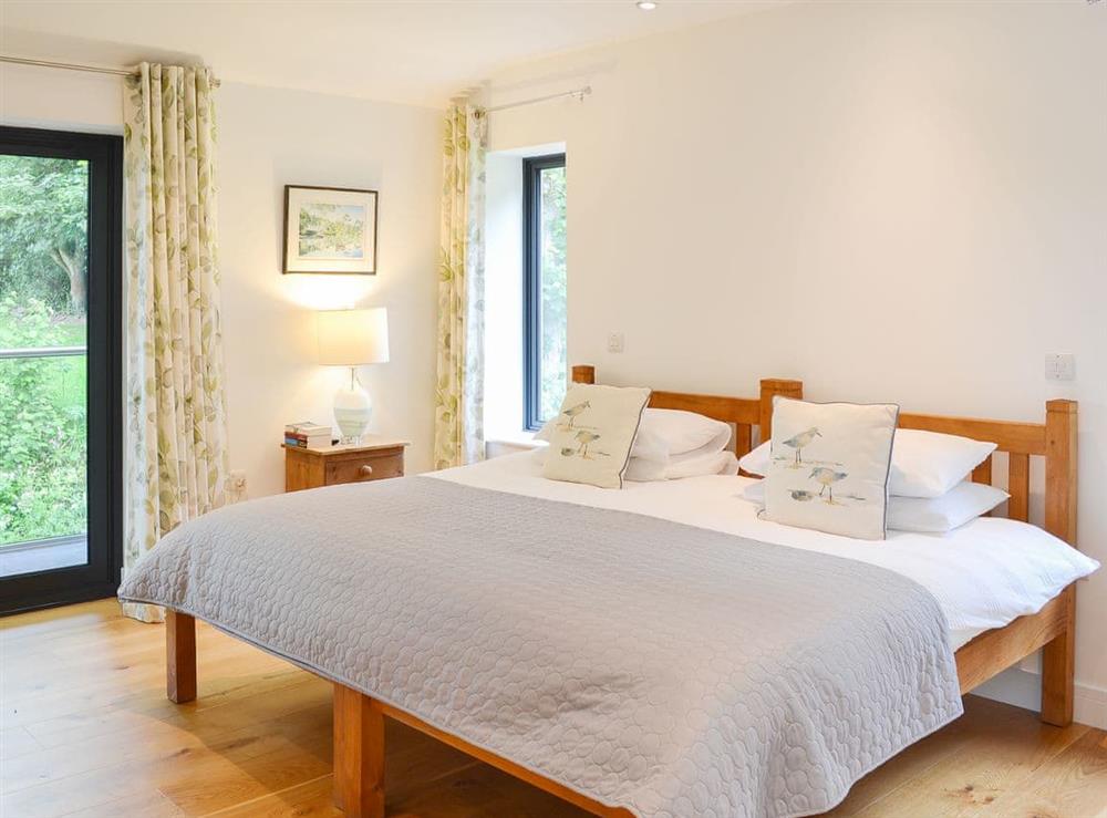 Bedroom with twin beds put together as a double at Lower Helland in Ladock, near Truro, Cornwall