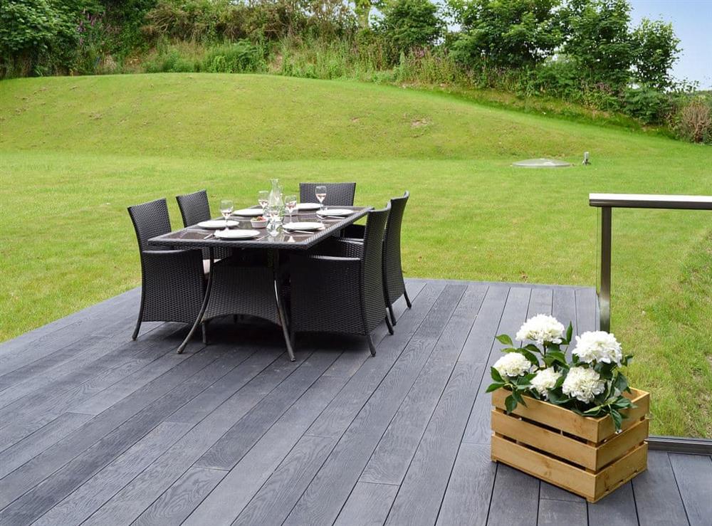 Decked area with furniture for alfresco dining at Lower Helland in Ladock, near Truro, Cornwall