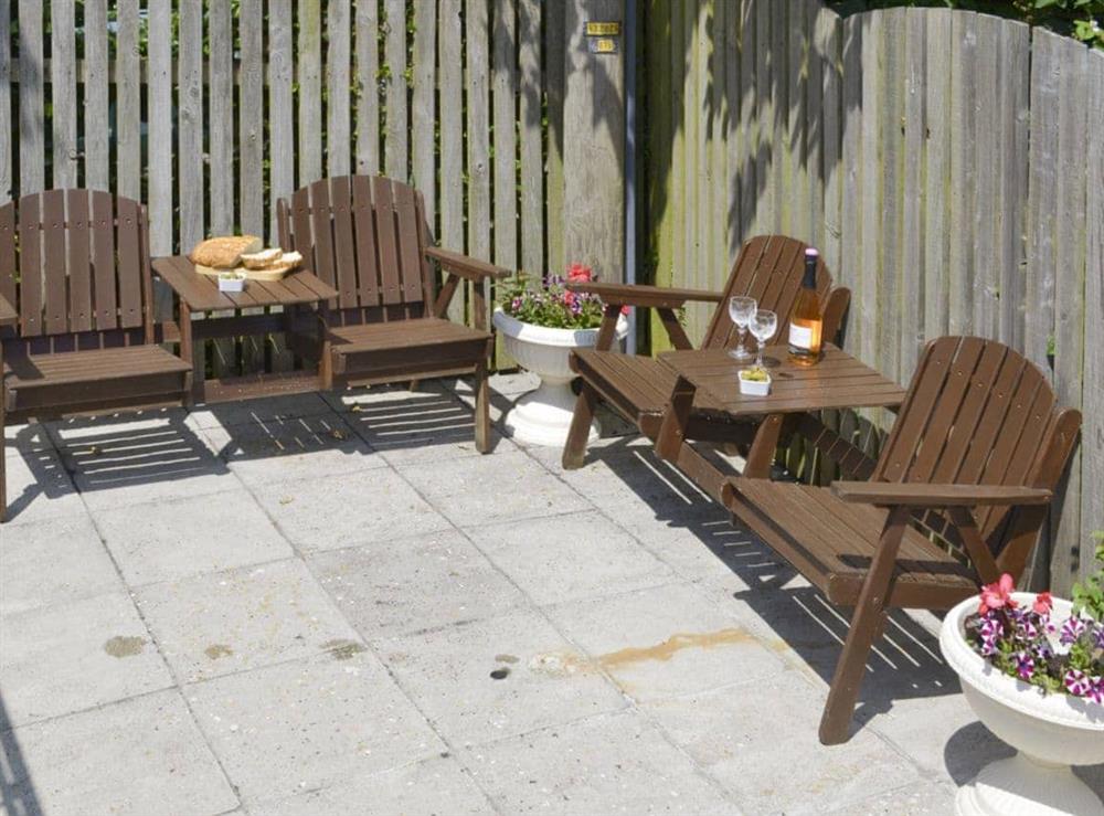Enclosed patio with outdoor furniture at Lower Moon in Port Isaac, Cornwall