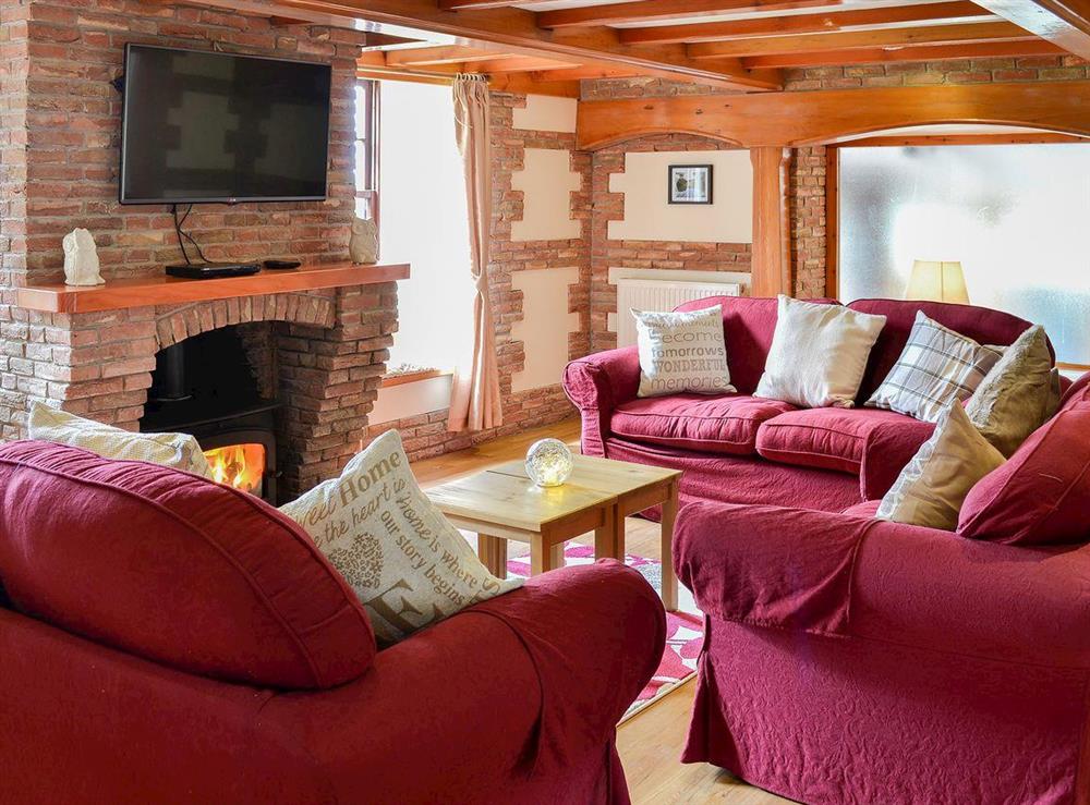 Comfortable living area with wood burner at Bridge House, 
