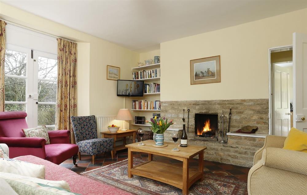 The spacious sitting room with open fire as a central feature at Lowfields, Sarsden