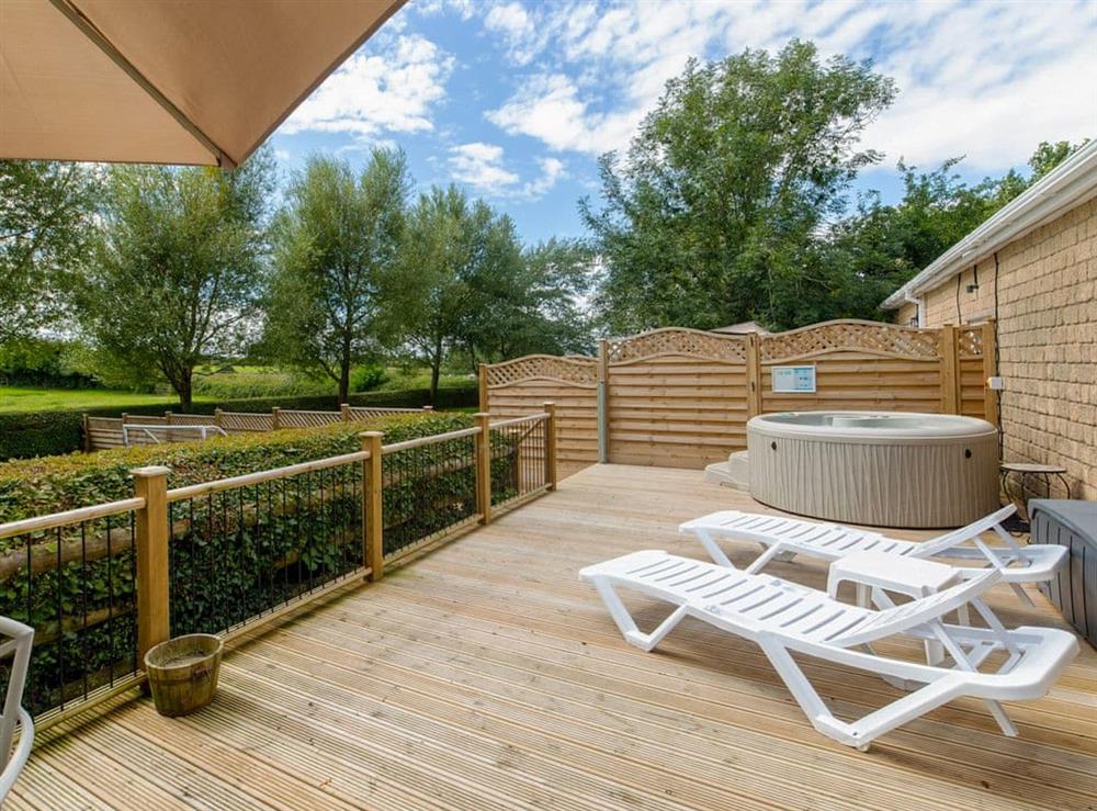 Decking area with hot tub at Luckington Stables 1 in Newbury, near Shepton Mallet, Somerset