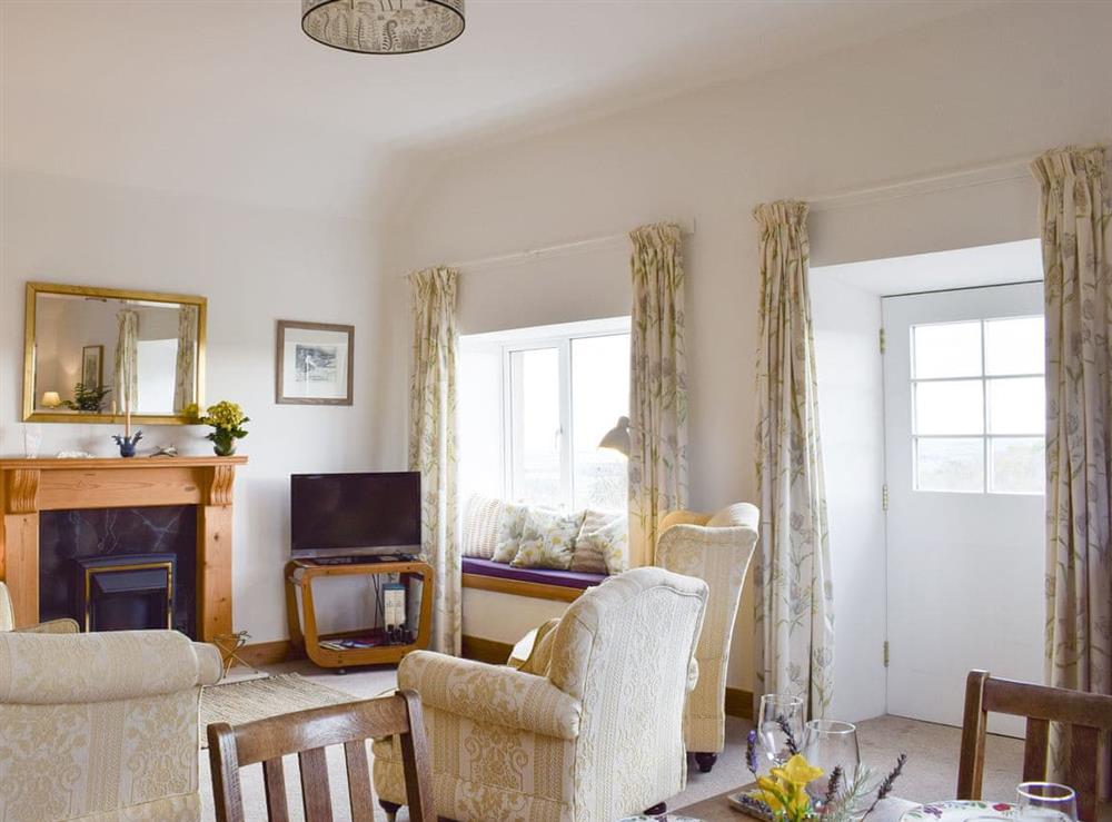 Welcoming living and dining room at Lucklaw Steading Cottage in Balmullo, near St Andrews, Fife
