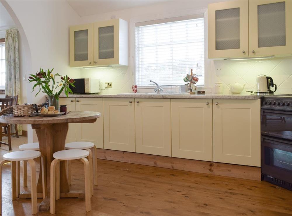 Well-equipped kitchen with informal dining area at Lucklaw Steading Cottage in Balmullo, near St Andrews, Fife