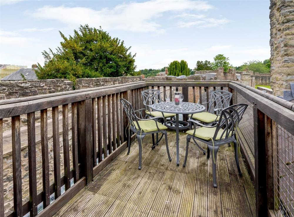 Decked roof terrace with outdoor furniture at Comus, 