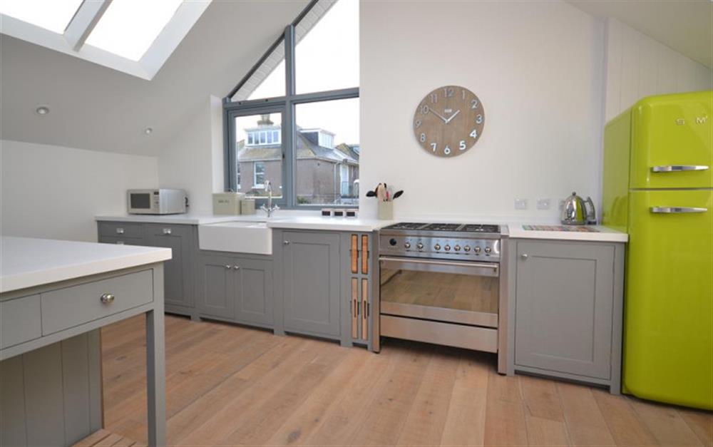 The kitchen area with Smeg fridge and cooker at Lundy in Salcombe