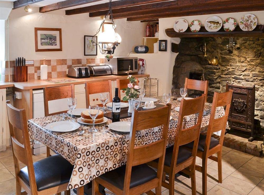 Kitchen/diner with beams and large fireplace at Lynches in Parkham, near Bideford, Devon