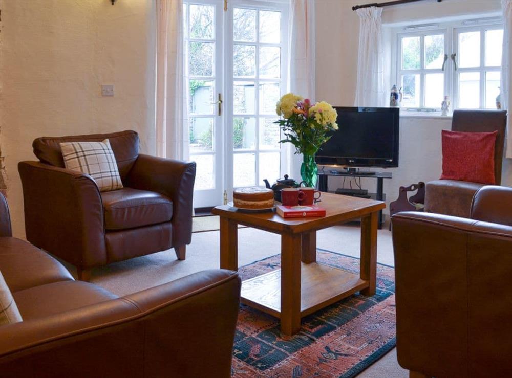 Living room with French doors to the courtyard at Lynches in Parkham, near Bideford, Devon
